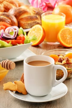 Breakfast including coffee, bread, honey, orange juice, muesli and fruits