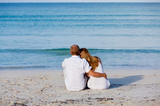 Young happy couple in love having fun on the beach in summer