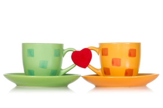 Two cups with red heart isolated on white background