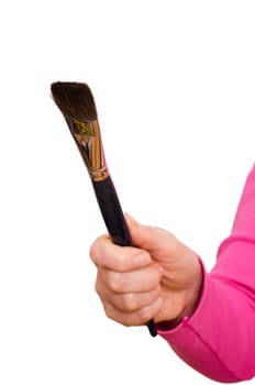 Female hand holding a brush for painting