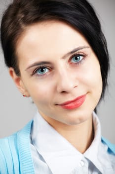 Portrait of a beautiful young businesswoman isolated on grey.