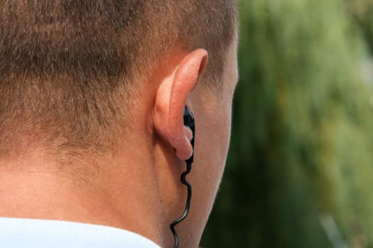 Back of male head with earphone