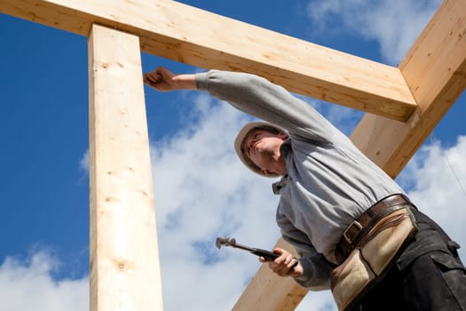 carpenter at work with wooden  roof construction