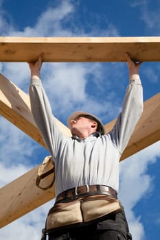 carpenter at work with wooden  roof construction