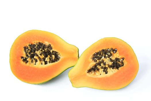 ripe papaya fruit (Carica papaya),halved and isolated against white background