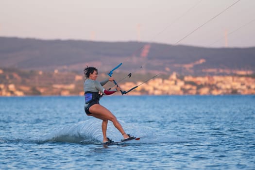 Gulbahce,Urla,Izmir,Turkey - July 30, 2023, People kite surf at the beach on a sunny afternoon in Gulbahce , Urla Izmir. High quality photo