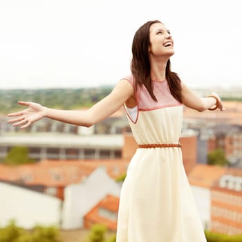 Woman, arms spread and happy by city, adventure and freedom on trip to Croatia, cityscape and sky. Female person, vacation and smiling or positive for getaway, energy and relaxing on holiday travel.