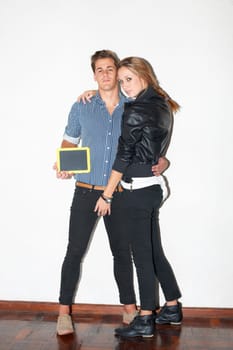 Portrait, education and chalkboard with a hipster couple on white wall background together for date. Fashion, love or learning space with a young man and woman on a school campus for relationship.
