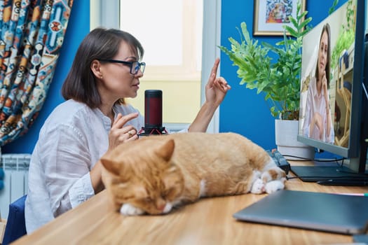 Online meeting conference, mature female talking to young woman in computer screen. Remote chat with colleague client patient student buyer employee. Work, technology, lifestyle concept