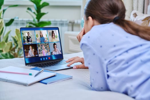 Video conference, teen girl student looking at laptop screen with group of teenagers studying remotely at home. Online lesson distance learning course. E-learning e-education technology high school