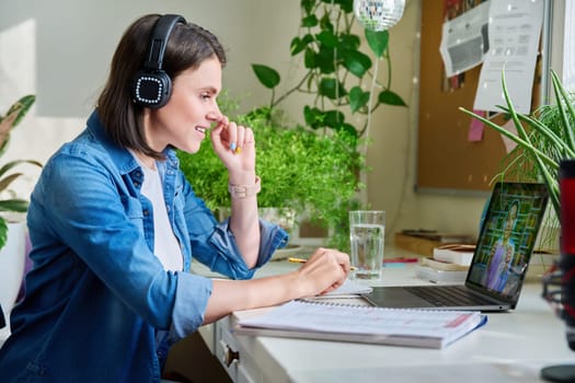 Young female teacher in headphones having video conference call with teenage girl student using laptop home. Online lesson e-learning distance remote classes technology in education knowledge school