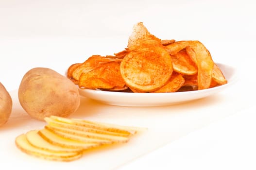 Potato chips,seasoned,on white plate
