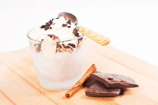 Ice cream dessert in a glass with chocolate and cream topping