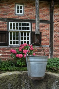 Draw well in front of a half-timbered house