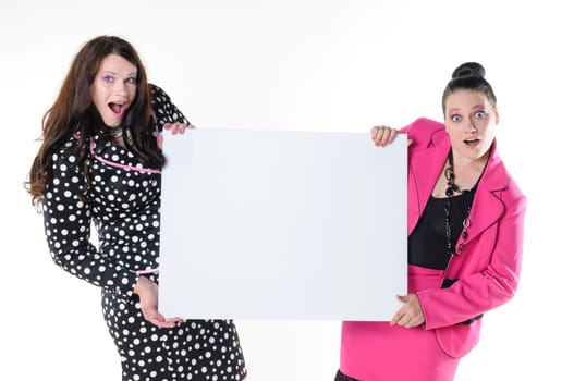 Two attractive plus-size models to wear flashy costumes and presenting a blank billboard, isolated against white background.