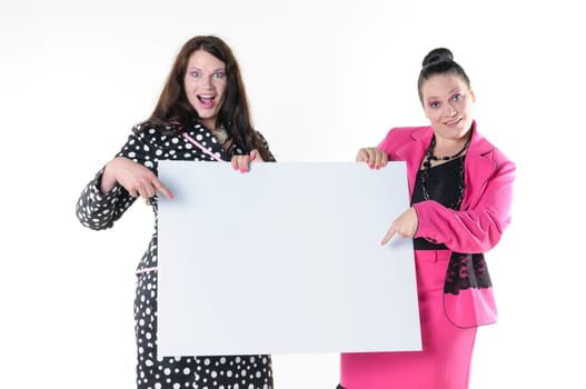 Two attractive plus-size models to wear flashy costumes and presenting a blank billboard, isolated against white background.