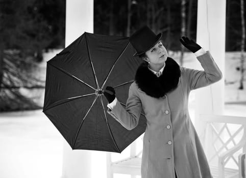 Shaded woman with umbrella feeling winter wind flow