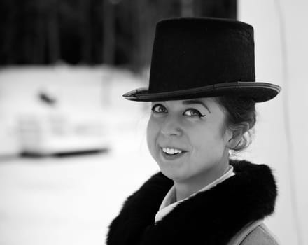 Shaded portrait of smiling young woman with hat