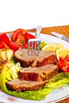 Roast with vegetables on a white background