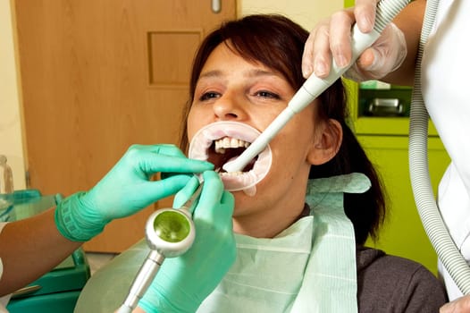 Dental treatment in a young woman in a dentist's office