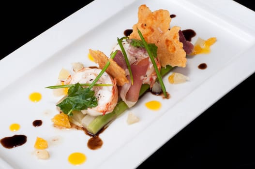 Lobster medallion with parma ham on asparagus and citrus dressing, balsamic dressing and parmesan cheese cracker