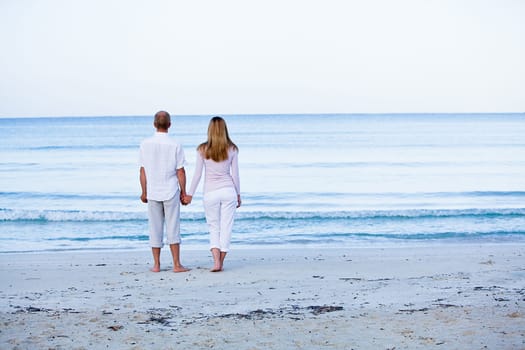 Young happy couple in love having fun on the beach in summer