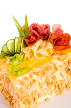 Salty pastry almond pie with cheese salami and cucumber topping