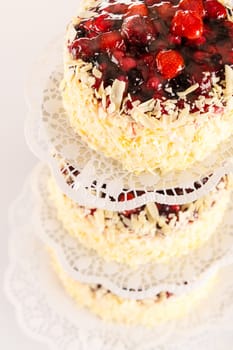 Stacked cake red berries and almonds white chocolate luxury decoration