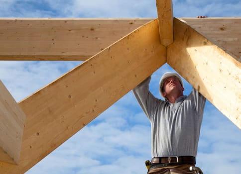 roofer at work with measuring construction