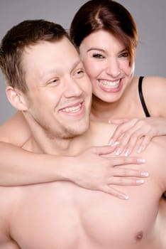 Studio shot of a young couple against a gray background