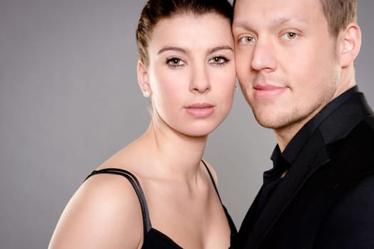 Studio shot of a young couple against a gray background