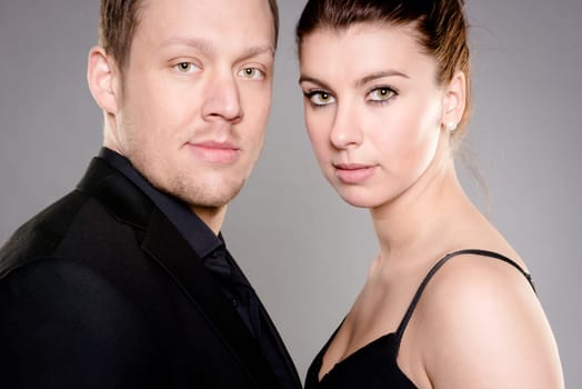 Studio shot of a young couple against a gray background