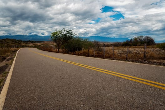 Winding road passing through a dry arid landscape