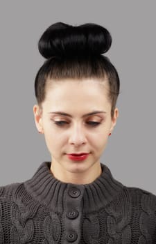 Portrait of a beautiful young woman over grey background.