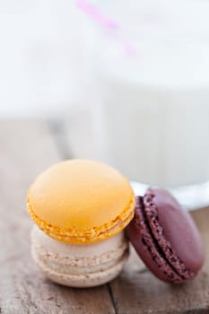 Closeup of three macaroons on wooden table surface