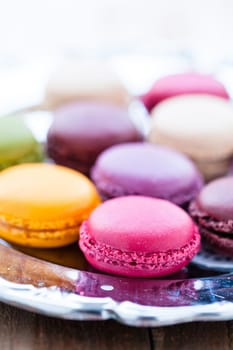Closeup of macaroons on decorative silver tray