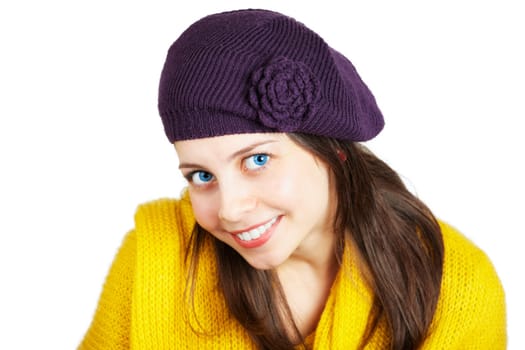 Portrait of a beautiful young woman with yellow scarf and purple hat over white.