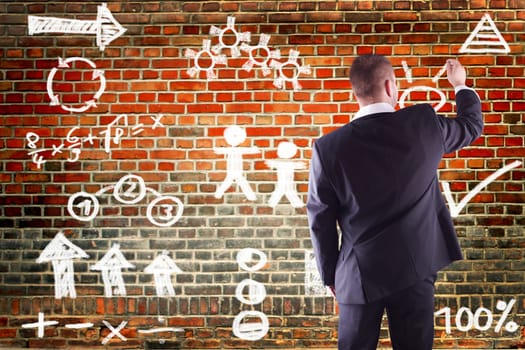 Businessman writing business plan to wall