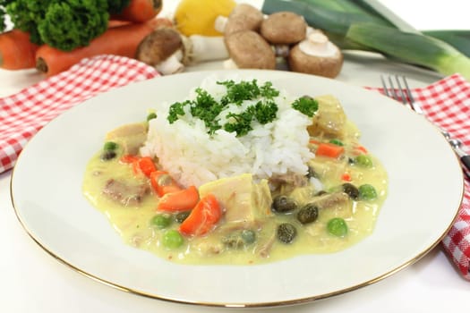 a plate of rice and colorful chicken fricassee