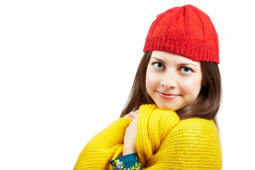 Portrait of a beautiful young woman with yellow scarf and red hat over white background.