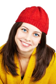 Portrait of a beautiful teenage girl with yellow scarf and red hat over white.