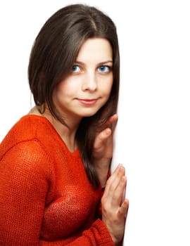 Portrait of a beautiful young woman with red top leaning against a white wall.