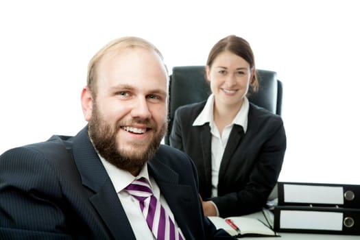 beard business man brunette woman at desk smile