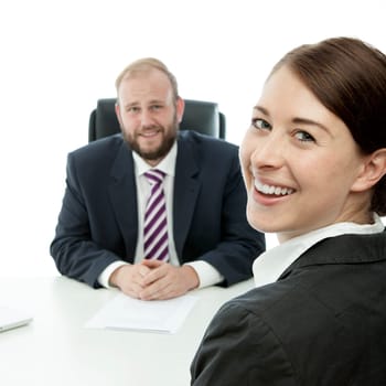 beard business man brunette woman at desk smiling
