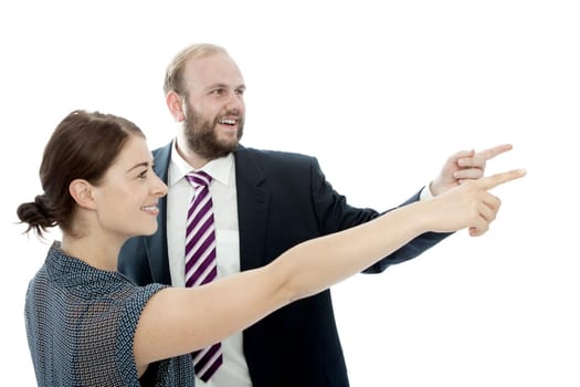 young brunette woman and beard business man points left