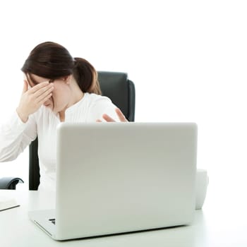 young brunette businesswoman with glasses is shocked on laptop