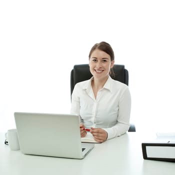 young brunette business woman smiling behind desk