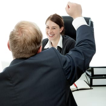 beard business man brunette woman at desk raise arms in the air