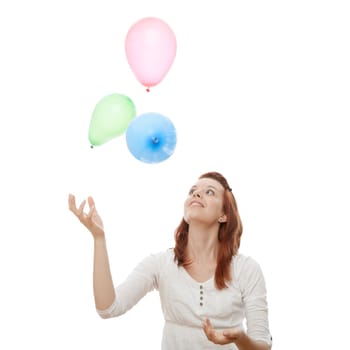 young beautiful red haired girl with ballons in front of white background