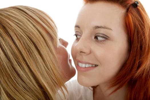 young beautiful red and blond haired girls in front of white background